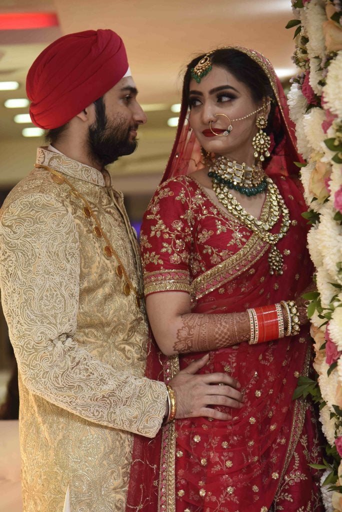 Maroon color lehenga and a golden sherwani make great color coordinated outfits. 