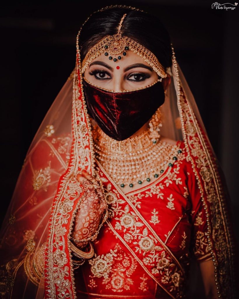 velvet red bridal face mask with kohl eye makeup and bold brows