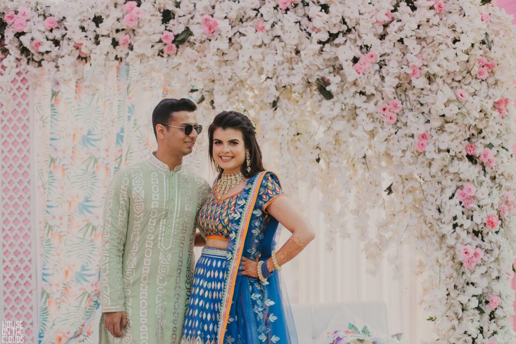 Palak & Pankaj in designer bridal wear for cute mehendi ceremony couple photography 
