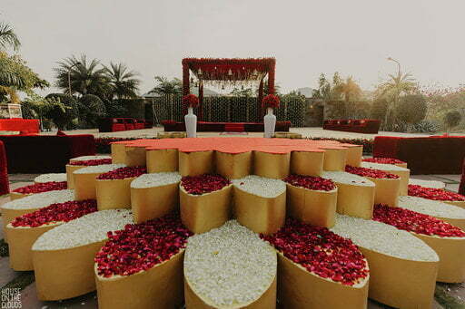 red and white flower decoration for open haldi stage