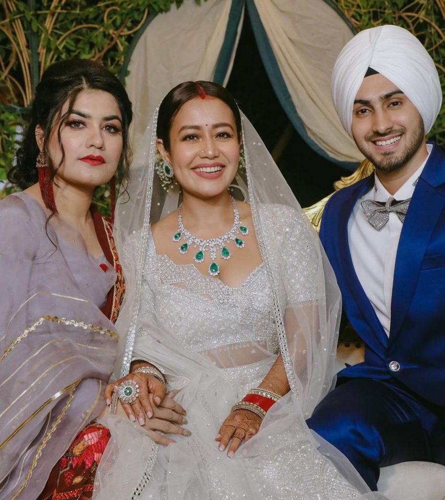 Neha Kakkar and Rohanpreet Posing for a shot with their guest at their wedding reception in Punjab