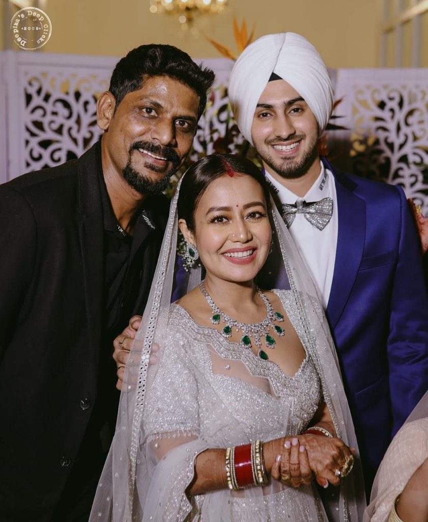 Neha Kakkar and Rohanpreet Singh from their Wedding Reception in Punjab posing for a shot with their guest