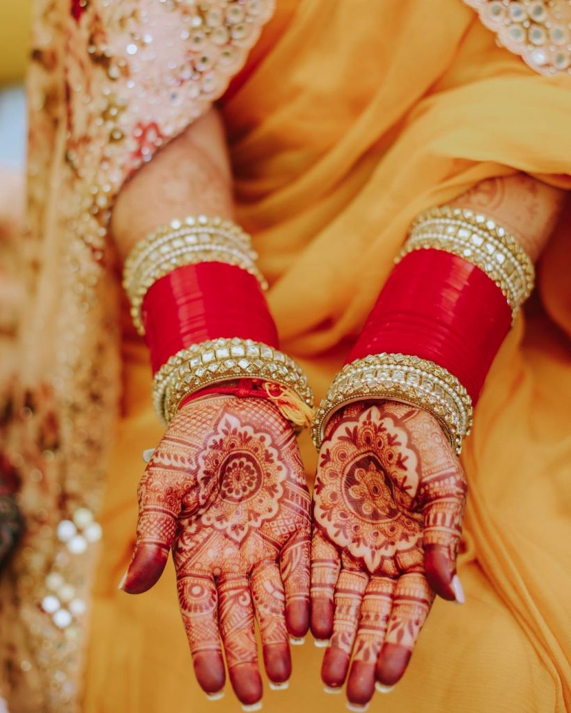 neha kakkar red bangle hands with mehendi for haldi ceremony