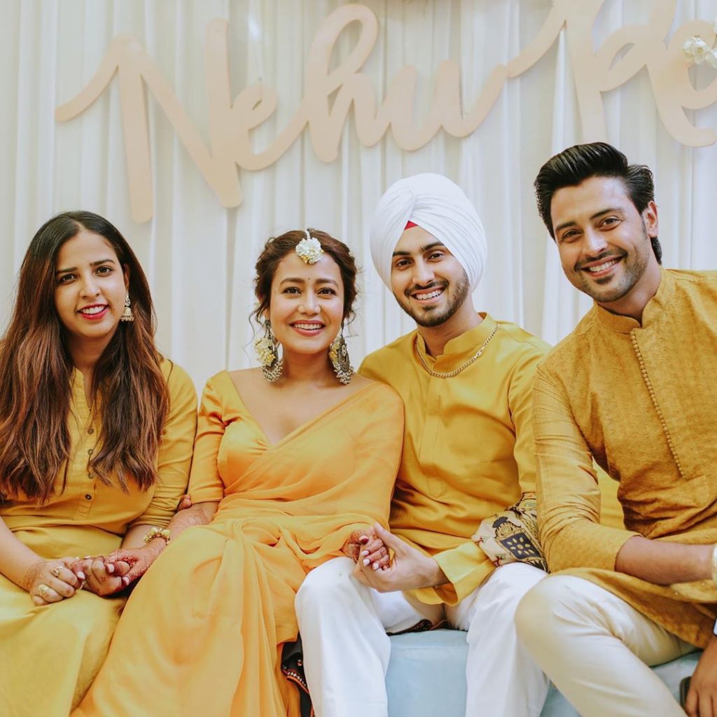 friends posing with neha and rohanpreet for haldi ceremony