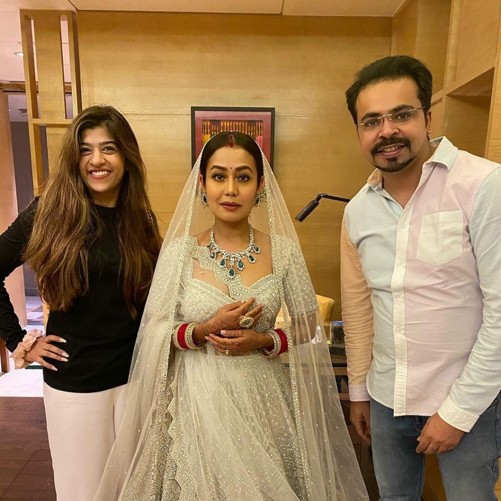 neha posing with reception guests in white lehenga