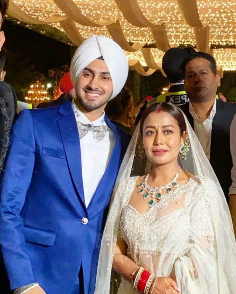 neha and rohanpreet in their Punjab reception with blue coat and white lehenga