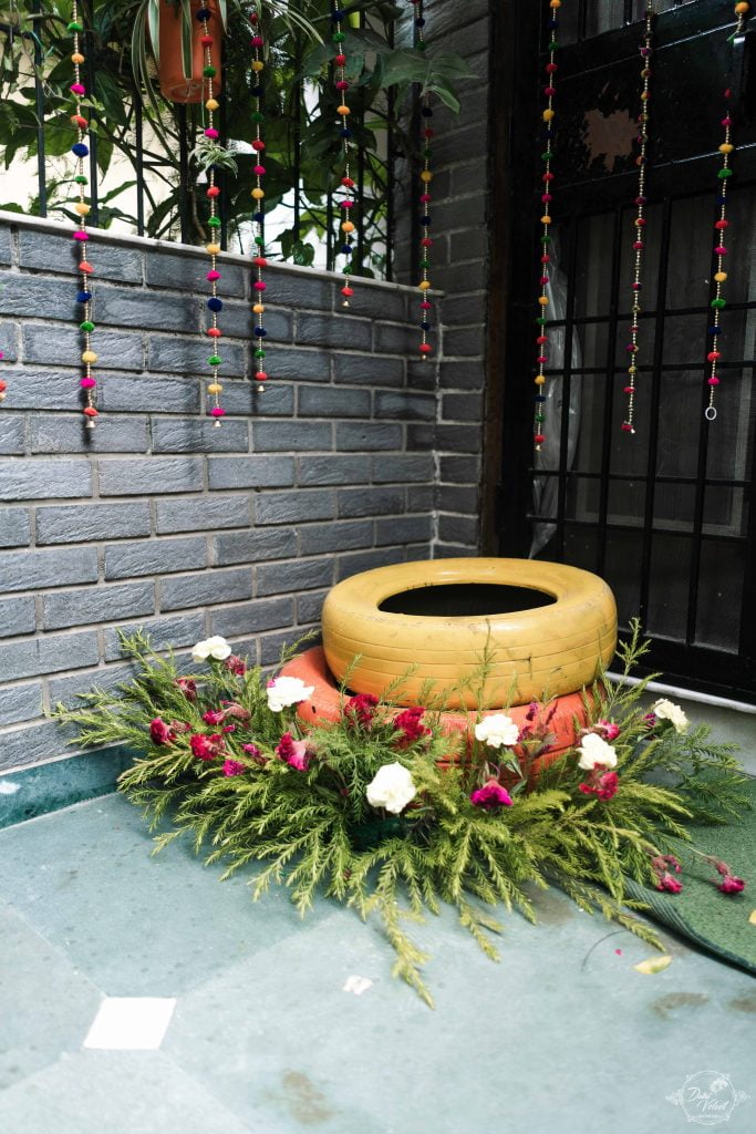 rustic painted tyres with flower bushes for indoor home decor
