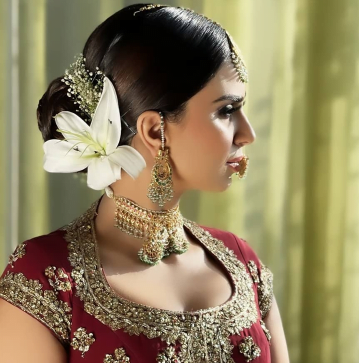 bride in a bridal bun with orchid flower