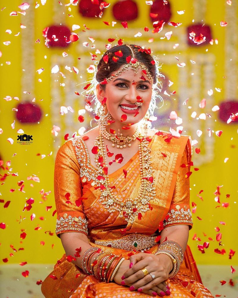 Photo of A south Indian bride poses in a kanjeevaram and temple jewellery