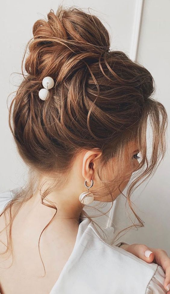 top knot high bun hairstyle with gown