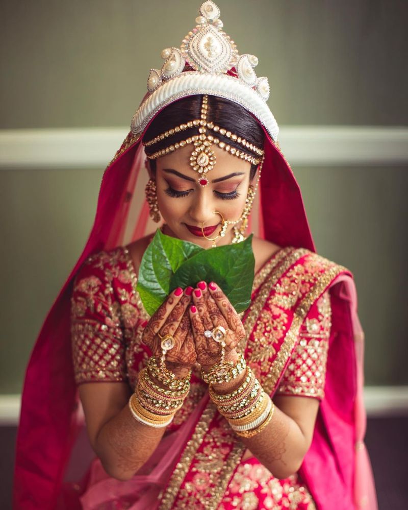 A bride wearing a face mask poses for a photo during the Mass Marriage  Ceremony. An NGO called 