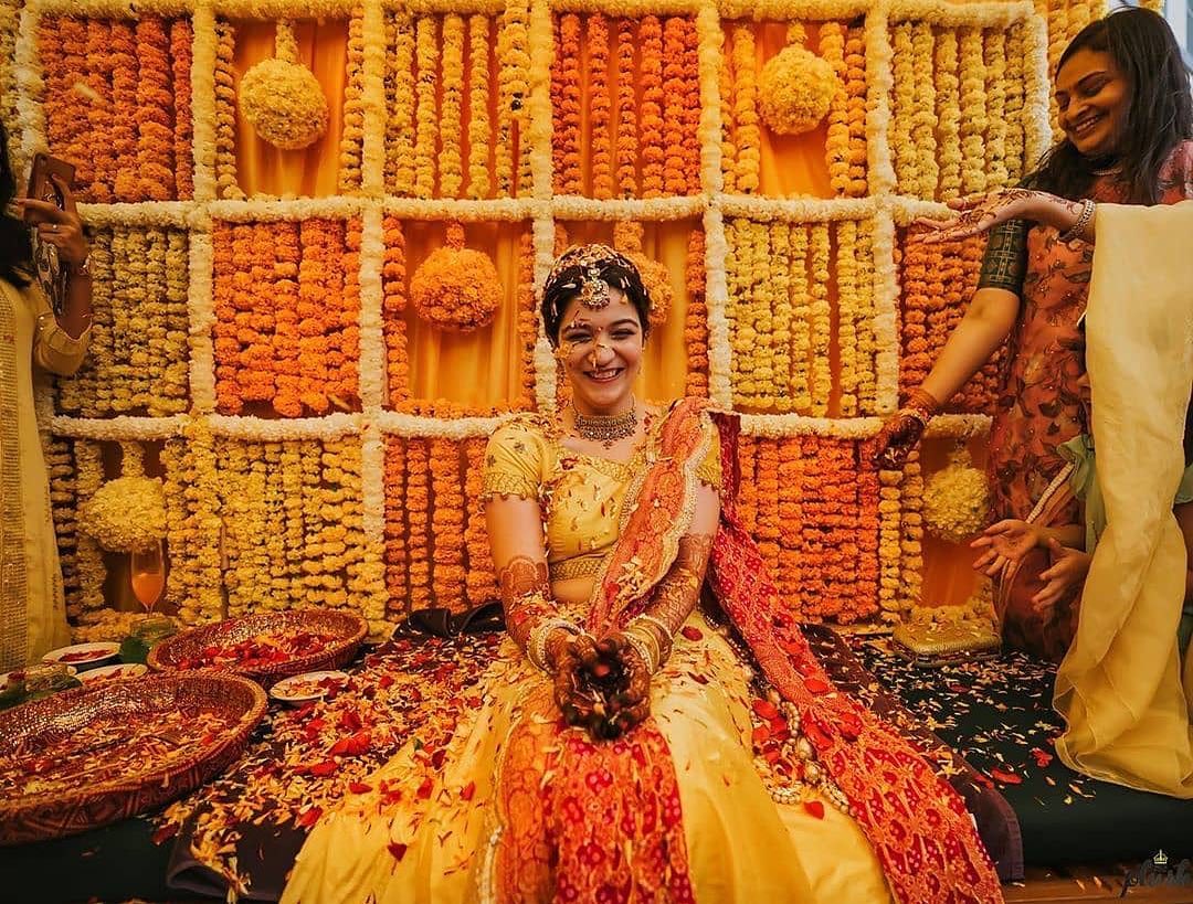 haldi-decoration-ideas-marigold-flower-background-haldi-ceremony-decoration  | WedAbout